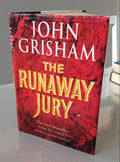 Book titled 'The Runaway Jury' by John Grisham with a red and black cover.