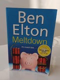 Book titled 'Meltdown' by Ben Elton with a pink piggy bank and red bombs on a blue background.