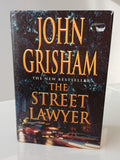 Book cover of 'The Street Lawyer' by John Grisham with a city street scene.