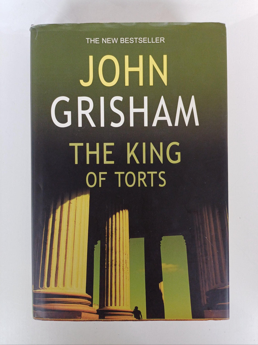 Book titled 'The King of Torts' by John Grisham on a white background